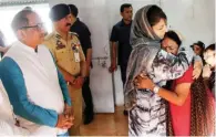  ?? - PTI ?? IN SHOCK: Jammu Kashmir Chief Minister Mehbooba Mufti consoles an Amarnath pilgrim who survived the Anantnag militant attack, before she was airlifted to New Delhi, at the airport in Srinagar. Deputy Chief Minister Nirmal Kumar is also seen.