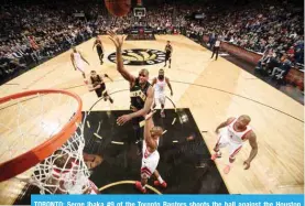  ??  ?? TORONTO: Serge Ibaka #9 of the Toronto Raptors shoots the ball against the Houston Rockets on Friday at the Air Canada Centre in Toronto, Ontario, Canada. — AFP