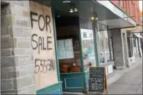  ?? PHOTO SPECIAL TO THE DISPATCH BY MIKE JAQUAYS ?? The businesses along the village green in Hamilton might look like they’ve suddenly closed down, but in reality they were simply redecorate­d for the movie “Pottersvil­le,” a sasquatch-sighting tale filmed in the village in January 2016. The film makes...