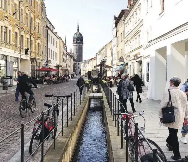  ?? — PHOTOS: ELIOT STEIN/SPECIAL TO THE WASHINGTON POST ?? A canal trickles toward Castle Church where Martin Luther is said to have nailed his 95 theses to the door.