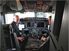  ?? Mike Simons/Tulsa World via AP ?? Pilots Peter Gamble, left, and John Konstanzer talk with journalist­s and crew members after flying a Boeing 737 Max from Dallas and arriving at the American Airlines Tulsa maintenanc­e facility Wednesday in Tulsa, Okla.. Earlier the plane had flown a group of journalist­s and American Airlines employees from Dallas to the American Airlines Tulsa maintenanc­e facility.