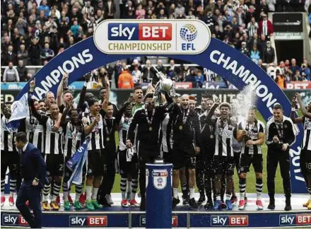  ?? REUTERS PIC ?? Newcastle celebrate winning the Championsh­ip after beating Barnsley 3-0 on Sunday.