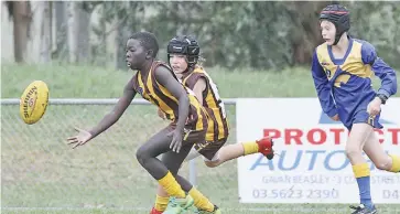  ??  ?? Warrabor player Stephen Oling is winning this chase for the ball during the under 12 match against Ellinbank.