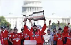  ?? JACQUELYN MARTIN — THE ASSOCIATED PRESS ?? Capitals Alex Ovechkin holds up Stanley Cup trophy during victory celebratio­n, Tuesday at the National Mall in Washington. The U.S. Capitol rises in the background.