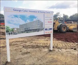  ?? J. SCOTT TRUBEY/ AJC ?? A sign marks the site for the future Georgia Cyber Innovation and Training Center in downtown Augusta. Gov. Nathan Deal and local leaders broke ground on the campus June 19 at the Augusta University downtown riverfront campus.