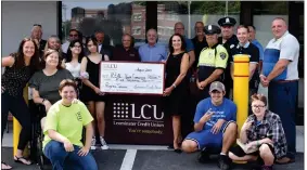  ?? COURTESY LEOMINSTER CREDIT UNION ?? Leominster Credit Union President and CEO Barbara Mahoney, right, holds up a check with Adamaris Rivera, a member of the Clinton REAL Mentors girls’ program, along with LCU staff and other mentorship program members.