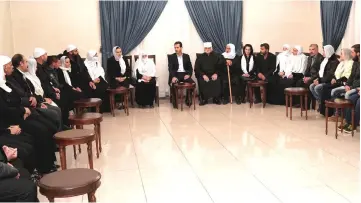  ??  ?? A handout picture released by the official Syrian Arab News Agency (SANA) shows Assad receiving a group of former Druze hostages and their families in the Syrian capital Damascus. — AFP photo