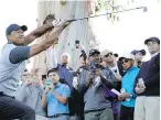  ??  ?? With the gallery looking on, Tiger Woods reacts as he watches his approach shot from the rough on the 12th hole during Thursday’s first round of the Genesis Open tournament in Los Angeles.