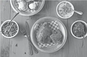  ?? TIM JOHNSON ?? Fried chicken with sides of succotash, collard greens, biscuits and white cheddar grits from the Eagle in the Short North.