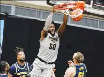  ??  ?? Purdue forward Trevion Williams (50) dunks over Michigan forward Austin Davis (51) during the first half of an NCAA college basketball game in West Lafayette, Indiana on Jan 22. (AP)