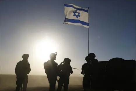  ?? Amir Levy/Getty Images ?? Israeli soldiers patrol near the border with Gaza on Monday in southern Israel. More details have emerged of a potential new cease-fire deal that could start before Ramadan, pending further negotiatio­ns by Israel, Hamas and foreign mediators.