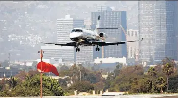  ?? Al Seib Los Angeles Times ?? AN AIRCRAFT lands at Santa Monica Municipal Airport. In 2016, Councilman Tony Vazquez, then mayor, got a free f light to Salinas from a private pilot. Vazquez did not list the f light on his 2016 disclosure form.