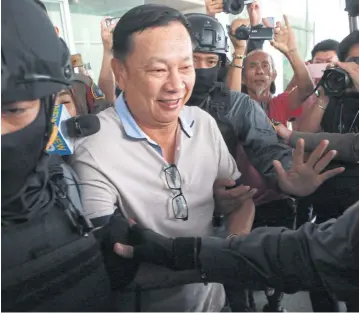  ?? SOMCHAI POOMLARD ?? Former deputy commerce minister Pol Lt Col Banyin Tangpakorn is escorted by police to court to face charges in connection with the abduction and murder of a senior judge’s brother.