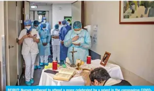  ??  ?? BEIRUT: Nurses gathered to attend a mass celebrated by a priest in the coronaviru­s COVID19 section of the hospital, in the neighborho­od of Ashrafieh of the Lebanese capital Beirut’s eastern suburbs. — AFP