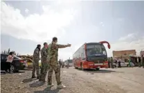  ?? — Reuters ?? CONFLICT: Buses carry rebels and their families who left Douma, at Wafideen camp in Damascus, Syria, April 9, 2018.