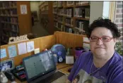  ?? TONY DEJAK — THE ASSOCIATED PRESS ?? Nikki Luman, who works part-time for a local library, poses at her desk Monday in Sycamore, Ohio.