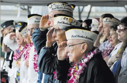  ?? Audrey Mcavoy The Associated Press ?? Pearl Harbor survivors salute during the national anthem at a ceremony in Pearl Harbor, Hawaii, on Friday marking the 77th anniversar­y of the Japanese attack.
