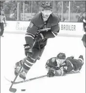  ?? Kyusung Gong Associated Press ?? THE DUCKS’ Carter Rowney (24) can’t quite reach the puck as Carolina’s Dougie Hamilton controls it.