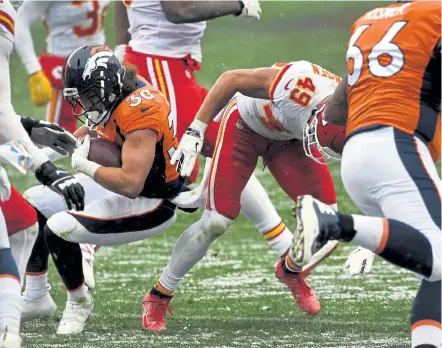  ?? Helen H. Richardson, The Denver Post ?? Broncos running back Phillip Lindsay suffers a concussion on a helmet- to- helmet hit by safety Daniel Sorensen ( 49) during the second quarter Sunday at Empower Field at Mile High.