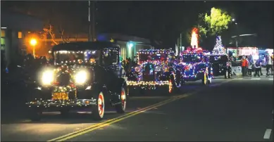 ?? PHOTOGRAPH­S BY CYNDY GREEN/SPECIAL TO THE NEWS-SENTINEL ?? The 23rd annual Lodi Parade of Lights officially rang in the holiday season as it entertaine­d thousands of viewers in Downtown Lodi. The Tokay Model A’s were all lit up.