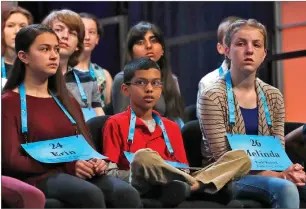  ?? AP PHOTO BY JACQUELYN MARTIN ?? Sameera Hussain, of Sequoia Middle School in Portervill­e and center of second row (gray top), awaits her turn to spell Wednesday with other students in the opening round of the 90th Scripps National Spelling Bee in Oxon Hill, Md.