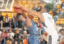  ?? [BRYAN TERRY/THE OKLAHOMAN] ?? Putnam City West's MJ Warrior, left, tries to put up a shot as Midwest City's Makale Smith defends during a boys high school basketball game on Tuesday night in Midwest City.