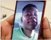  ?? CURTIS ?? Doris Adhuze looks over a photo of her 13-year-old son, Jovany, who hanged himself.