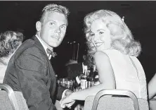  ?? / Associated Press ?? Tab Hunter with actress Tuesday Weld at a 1959 dinner in Los Angeles. Hunter, the epitome of the all-American boy in the movies, revealed in his 2005 autobiogra­phy that he was gay.