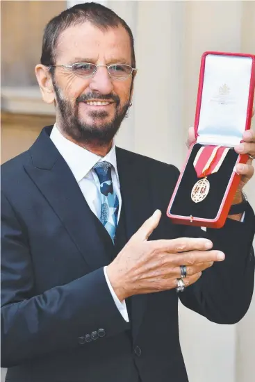  ?? Picture: AFP ?? SO FAB: Richard Starkey, better known as Ringo Starr, poses with his medal after being appointed Knight Commander of the Order of the British Empire.