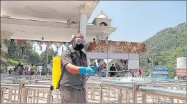  ?? ANI ?? A worker sprays disinfecta­nt on the railings at Vaishno Devi premises ahead of the Navratri preparatio­n in Katra on Monday.