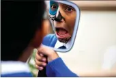  ?? SARAH REINGEWIRT­Z — STAFF PHOTOGRAPH­ER ?? Andrew Martinez, 9, of Our Lady of Miraculous Medal School, checks out his sugar skull airbrushed on his face at Calvary Cemetery in East Los Angeles on Wednesday.