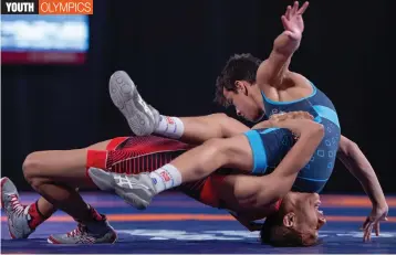  ?? AFP ?? Mexican Axel Andre Salas Esquivel ( bottom) and Argentina’s Eduardo Lovera compete in the men’s Greco- Roman wrestling 51kg bronze medal match during the Youth Olympic Games in Buenos Aires. —
