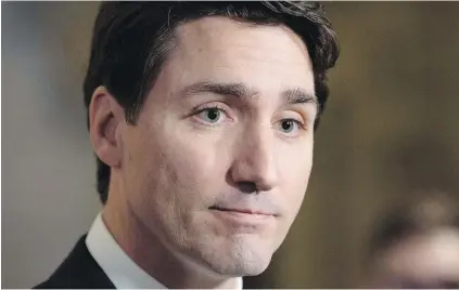  ?? ADRIAN WYLD, THE CANADIAN PRESS ?? Prime Minister Justin Trudeau speaks with the media in the foyer of the House of Commons after the release of an ethics report in Ottawa on Wednesday. The Trudeaus’ visits to a private Bahamian island owned by the Aga Khan violated the Conflict of...