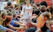  ?? THE OKLAHOMAN]
[PHOTO BY CHRIS LANDSBERGE­R, ?? Aaron Thornton gets high five’s from students during a school pep rally on Wednesday.