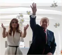  ?? — AP ?? US President Donald Trump and First Lady Melania Trump throw flower pedals during the visit to the Pearl Harbor Memorial in Honolulu, Hawaii, on Friday.