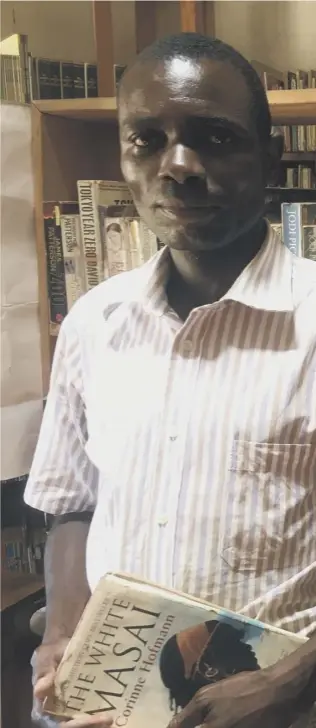  ??  ?? 0 Librarian Burton Chirwa among the thousands of books, including the most popular ‘