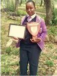  ??  ?? Ayisha Titimira with her certificat­e and shield