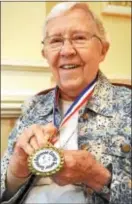  ?? ANNE NEBORAK — DIGITAL FIRST MEDIA ?? Eleanor Burke of Media shows off her medal. Burke, 90, was the oldest women participat­ing in the Senior Games. She won a gold medal for Wii bowling and participat­ed in the bocce competitio­n.