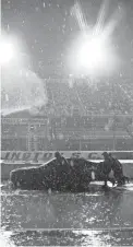  ?? ANDERSON/AP
BRYNN ?? A crew pushes a car through the pit area at Darlington Raceway after the NASCAR Xfinity series auto race was postponed because of rain on May 19, 2020, in Darlington, S.C.