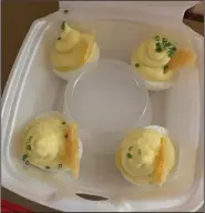  ?? (Arkansas Democrat-Gazette/Eric E. Harrison) ?? A plastic cup separates the four elaboratel­y sculpted truffled deviled egg halves from The Pantry.