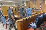  ?? PARKER PERRY / STAFF ?? Octavius Lamont Humphrey, 42, is escorted out of the courtroom Thursday morning after being sentenced for a triple murder.