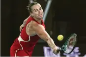  ?? ANDY WONG / ASSOCIATED PRESS ?? Aryna Sabalenka plays a backhand return to Zheng Qinwen during a successful defense of her Australian Open women’s singles title Saturday. Sabalenka is the first woman since Victoria Azarenka in 2012 and 2013 to win back-to-back.