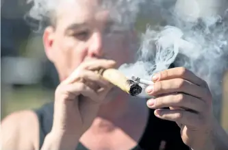  ?? GETTY FILES ?? Above: A man smokes marijuana. A number of provincial government­s are expressing concern in the wake of signals that federal legislatio­n to legalize pot will be introduced the week of April 10 — just 10 days before annual “Weed Day” celebratio­ns held...