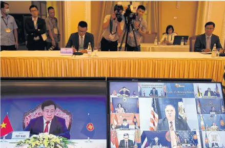  ?? AFP ?? Vietnam’s Foreign Minister Pham Binh Minh, left screen, and US Secretary of State Mike Pompeo, centre on right screen, during the Asean-US Ministeria­l Meeting in Hanoi on Sept 10.