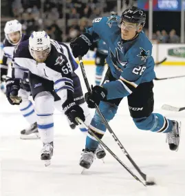  ?? NHAT V. MEYER/STAFF ?? The Sharks’ Timo Meier (28) shoots against the Jets’ Mark Scheifele in the third period.