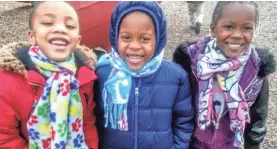  ??  ?? Kindergart­ners Manasseh Smith, from left, Larry Palmer and Ti’miya Summers wear scarves made by Jeffrey Thomas. JEFFREY THOMAS