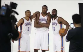  ?? SUE OGROCKI - THE ASSOCIATED PRESS ?? FILE - In this Dec. 13, 2011, file photo, Oklahoma City Thunder’s Russell Westbrook (0), Kevin Durant, center, and James Harden (13) pose for a photo for NBA basketball photograph­ers during media day in Oklahoma City.