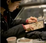  ?? BLOOMBERG ?? A customer looks at gold bracelets in a Chow Tai Fook jewelry store in Hong Kong.