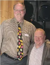  ??  ?? The event was a success thanks to volunteers like Jonathan Hector, left, and Gary McCowen of Canadian Progress Club Calgary Bow River.