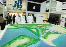  ?? Abdul Rahman/ Gulf News ?? Investment options Abu Backer Al Khouri, Chairman of Aldar, Saleh Rashid Al Dhahiri, a UAE businessma­n, and Khalid Mohammad Al Badie, vice- president of Al Badie Group for Trading & Investment­s, with other visitors look at the projects by Al Dar on Yas...